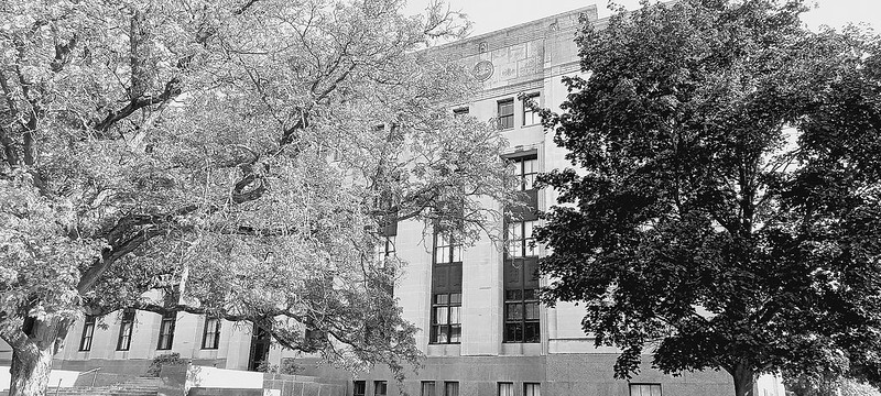 Historic building and trees in Kalamazoo, Michigan, symbolizing nonprofit institutions and systems of power examined in the investigation “Nonprofits Without Accountability.”