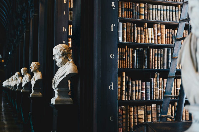 Interior of a historic law library with shelves of legal books and classical busts.