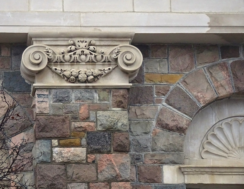 Architectural detail of the George P. Glazier Memorial Building in Chelsea, Michigan, showing stonework and classical design elements.