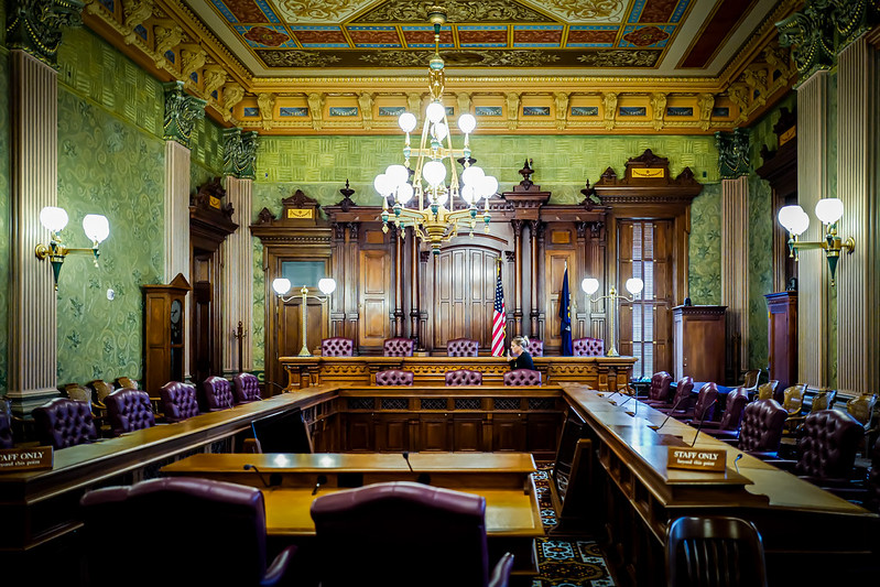 Interior of the original Michigan State Supreme Court chamber in Lansing, Michigan, showing judicial benches, seating, and architectural detail.