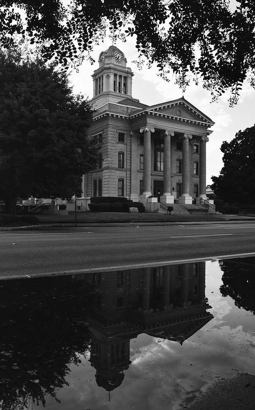 Black-and-white photograph of a courthouse building, reflecting the formal and procedural nature of the legal system.