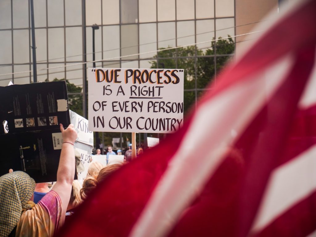 Protest sign stating due process is a right, representing judicial fairness, civil rights, and legal accountability